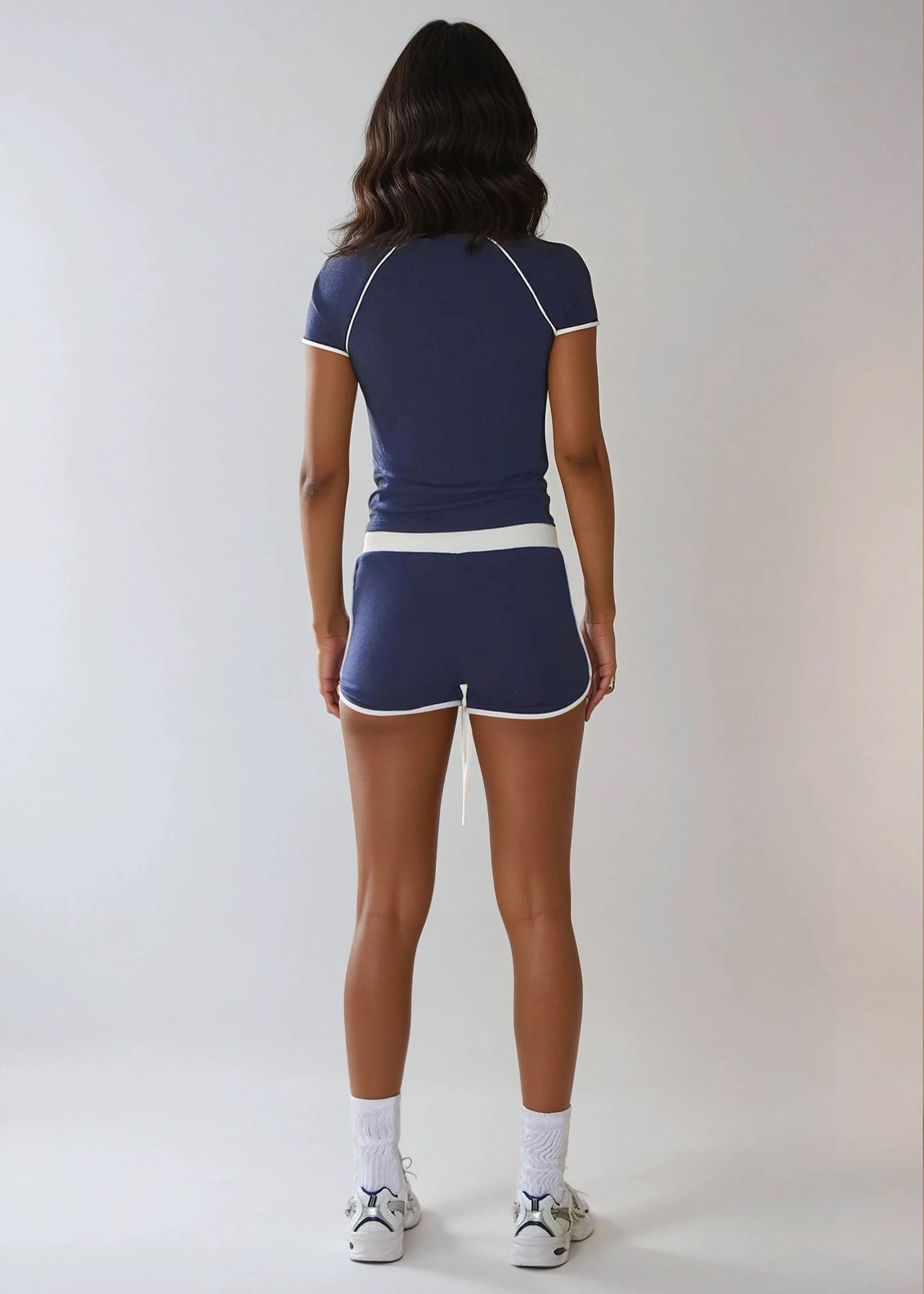 The Weekend Stride Short Sleeve Top & Shorts Set combines soft jersey fabric, two-tone stripes, and a fitted silhouette for a sporty, comfortable style.