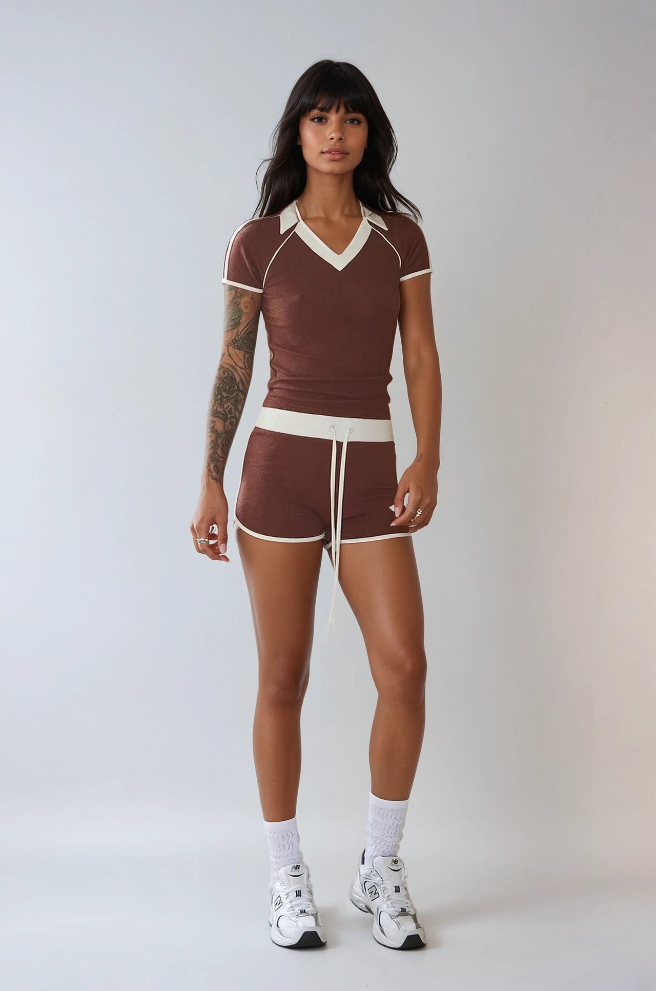 The Weekend Stride Short Sleeve Top & Shorts Set combines soft jersey fabric, two-tone stripes, and a fitted silhouette for a sporty, comfortable style.