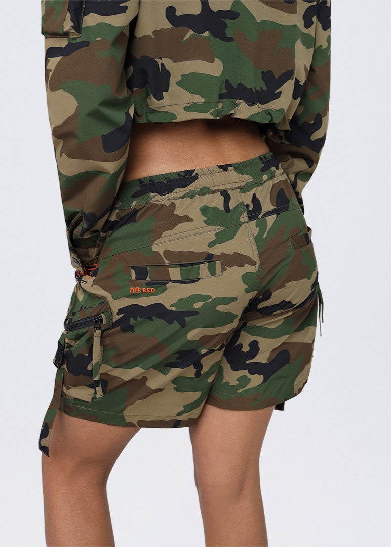 Step into quiet confidence with the Whispering Shadow Nylon Camo Shorts, featuring utility slouch fit, cargo pockets, double drawstrings & stretchy nylon fabric.
