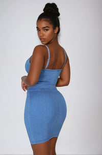 Thumbnail for Woman wearing a blue denim two piece crop top and skirt set against a white background